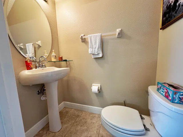 a bathroom with a sink mirror toilet and bathroom