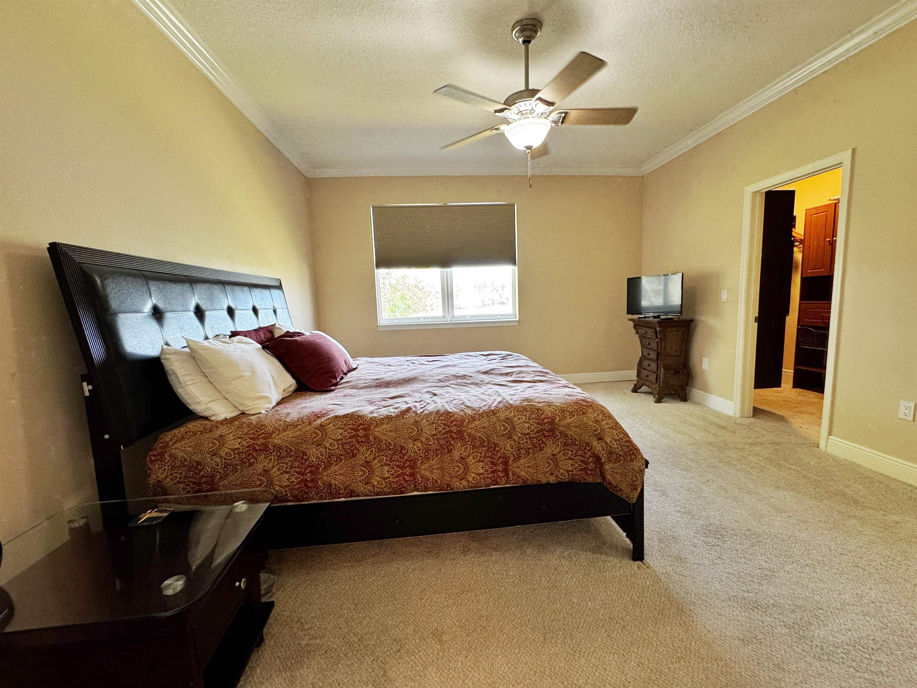 80 Riverview Bend South, Unit 814 Palm Coast, FL 32137 - Photo 21 of 39 a bedroom with a large bed and a chandelier