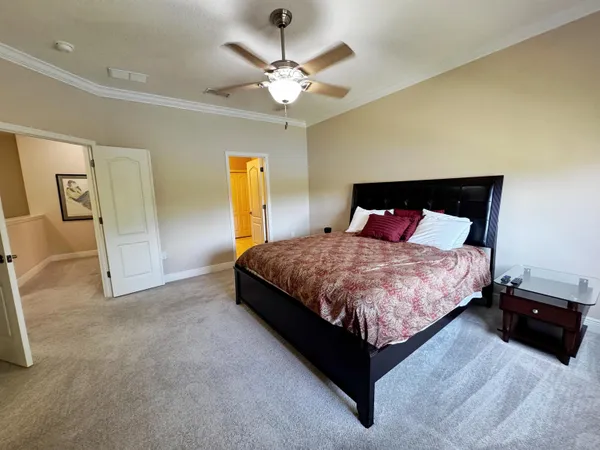 a bedroom with a bed and ceiling fan