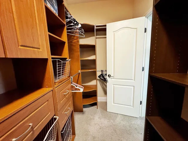 a view of walk in closet with empty racks