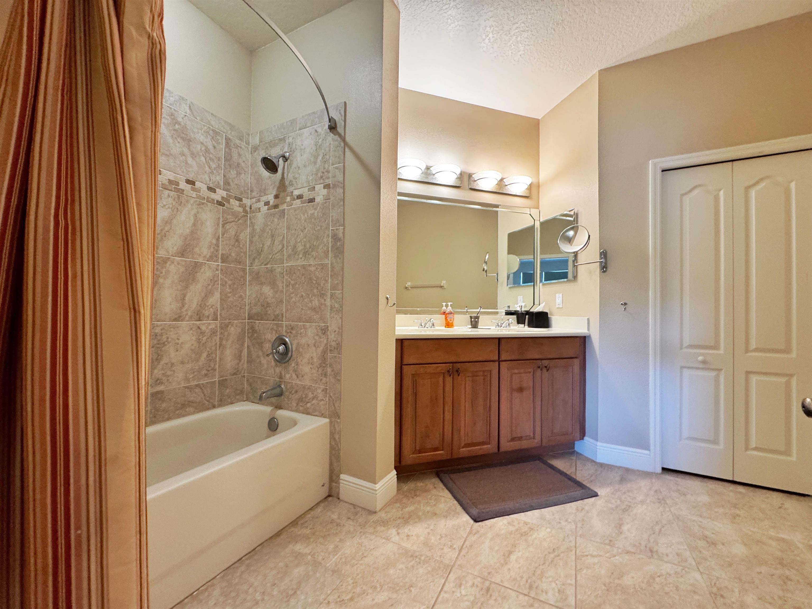 80 Riverview Bend South, Unit 814 Palm Coast, FL 32137 - Photo 26 of 39 a bathroom with a bathtub sink and mirror