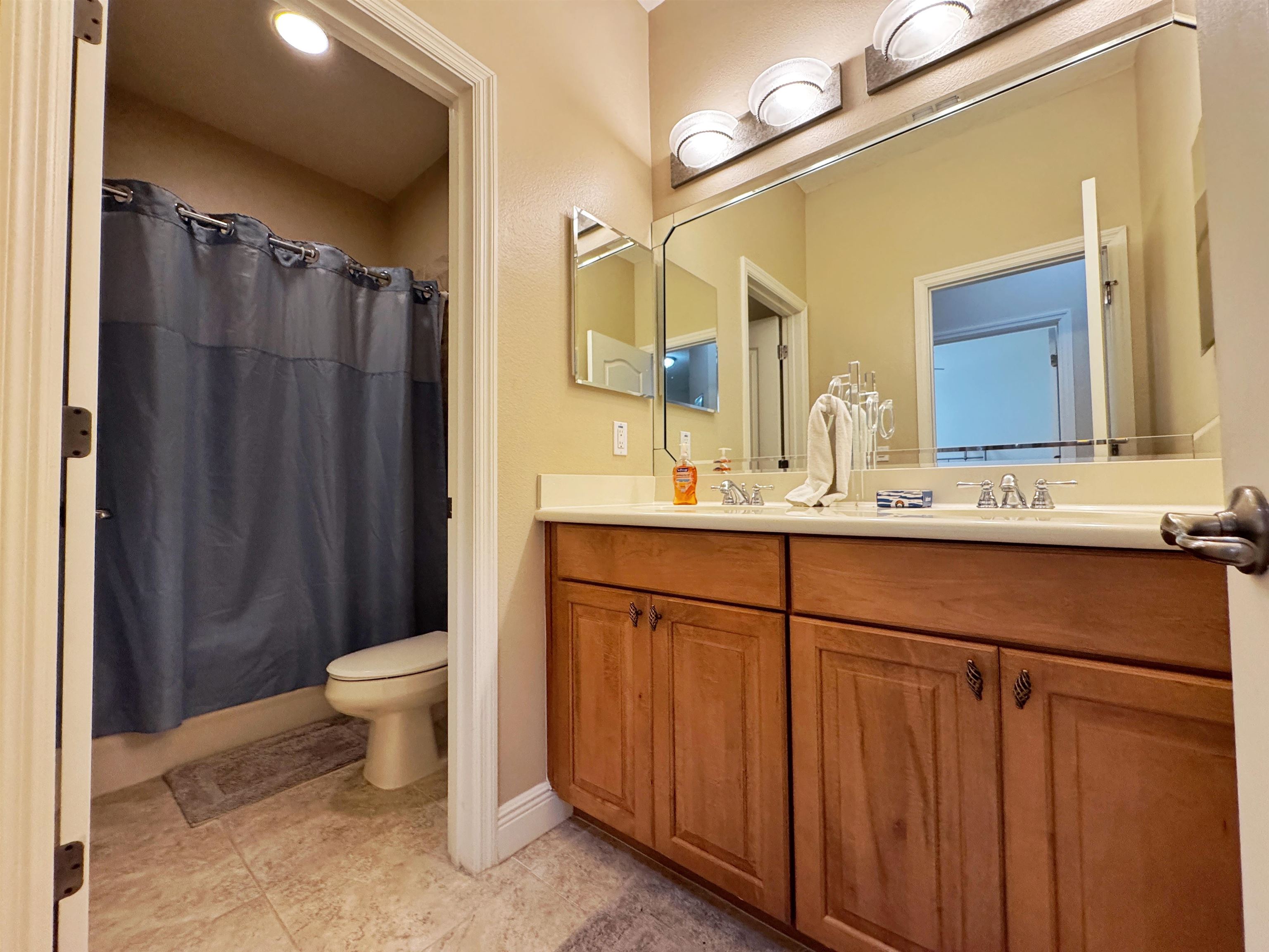 80 Riverview Bend South, Unit 814 Palm Coast, FL 32137 - Photo 30 of 39 a bathroom with a sink toilet a mirror and shower