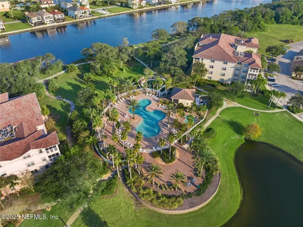 an aerial view of a house with a swimming pool