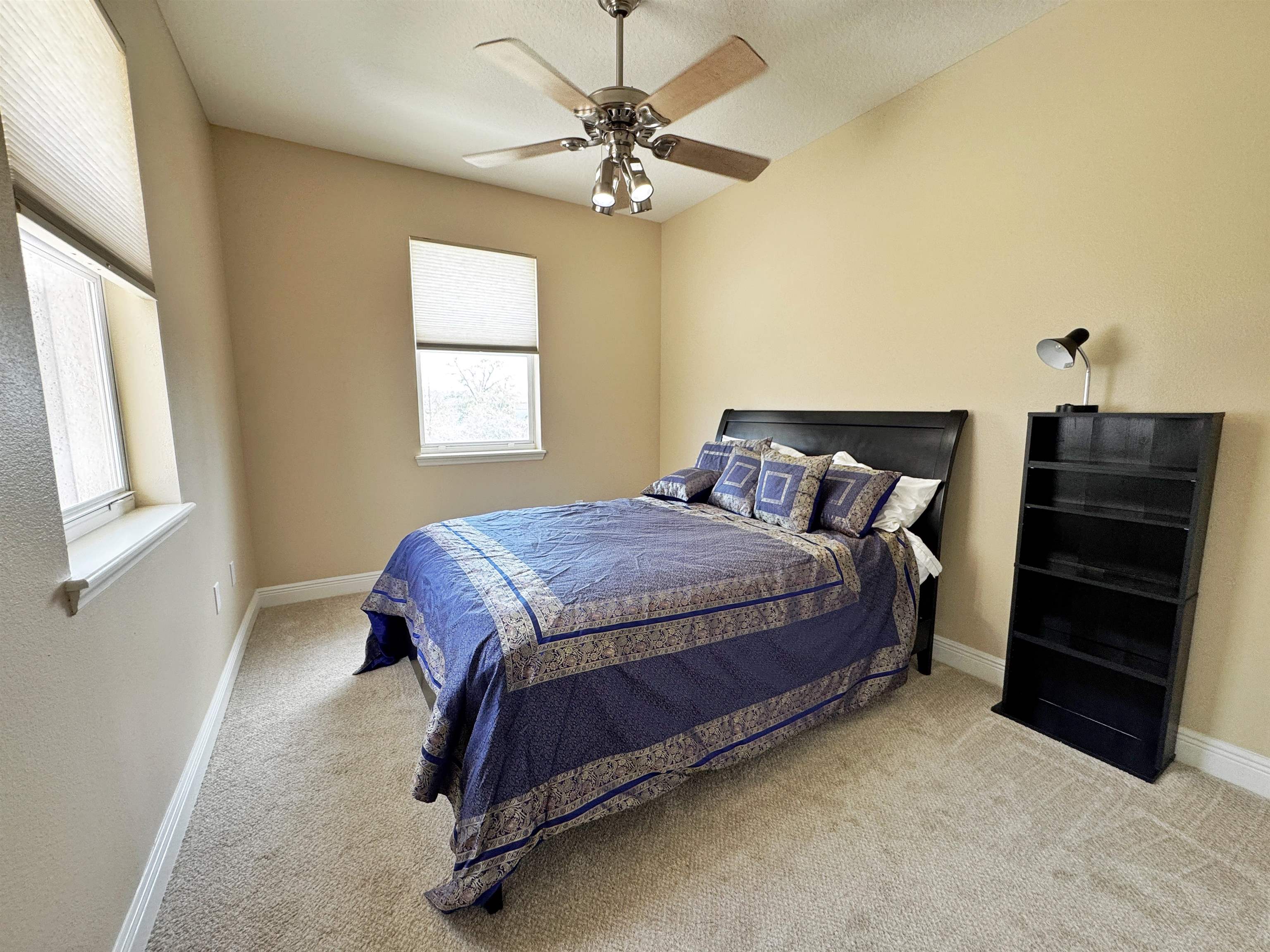 80 Riverview Bend South, Unit 814 Palm Coast, FL 32137 - Photo 32 of 39 a bedroom with a bed and a ceiling fan