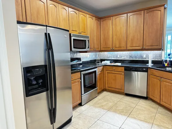 a kitchen with a sink stove and refrigerator