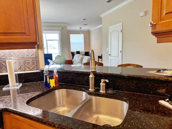 a kitchen with a sink and a stove top oven