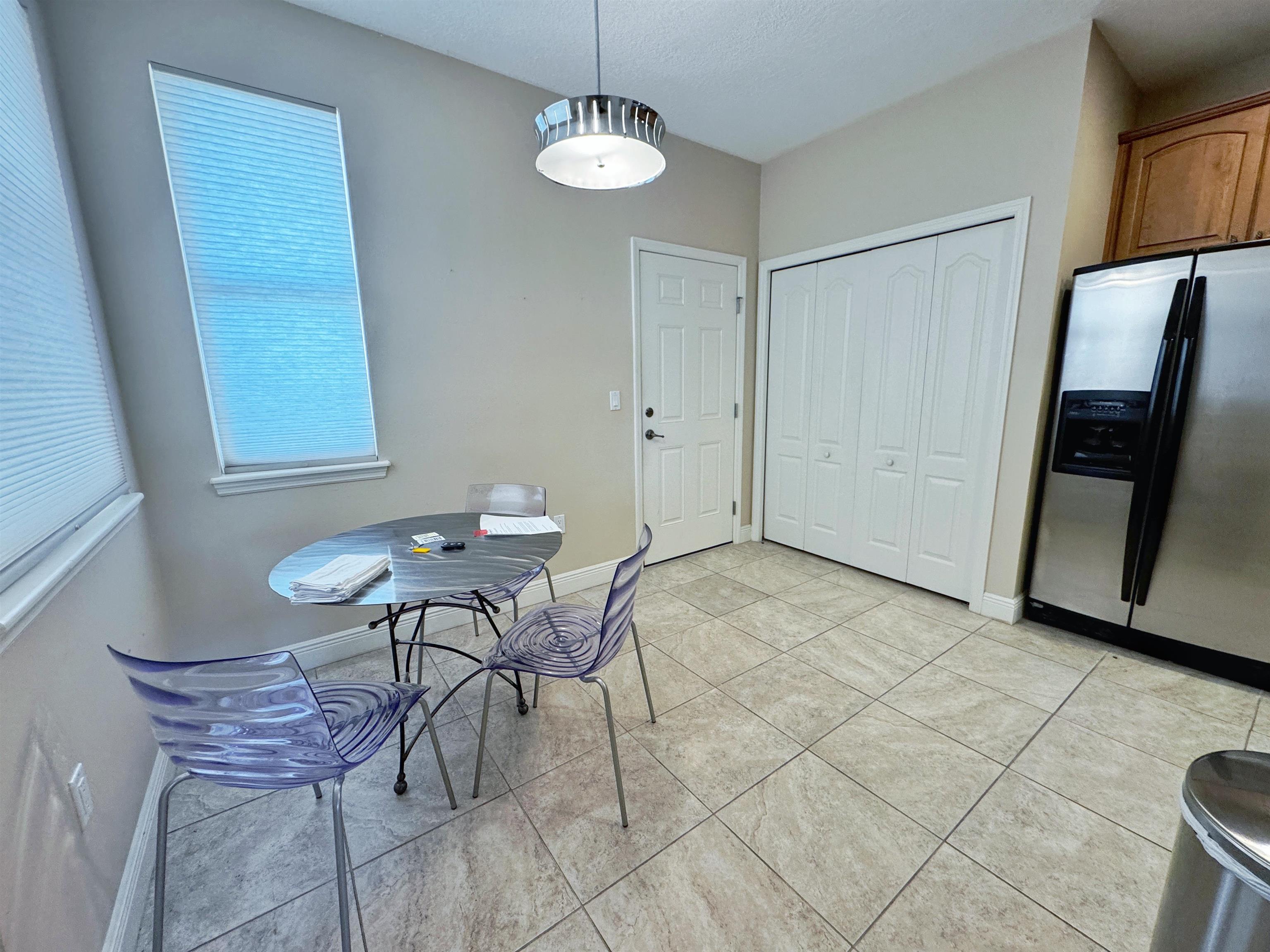80 Riverview Bend South, Unit 814 Palm Coast, FL 32137 - Photo 9 of 39 a view of a room with breakfast area and chandelier
