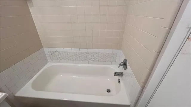 a bathroom with a toilet a sink and a mirror