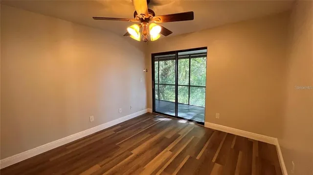 wooden floor in an empty room with a window