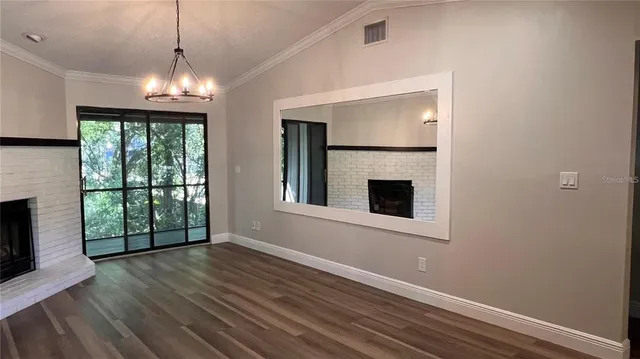 a view of a living room a kitchen and a chandelier