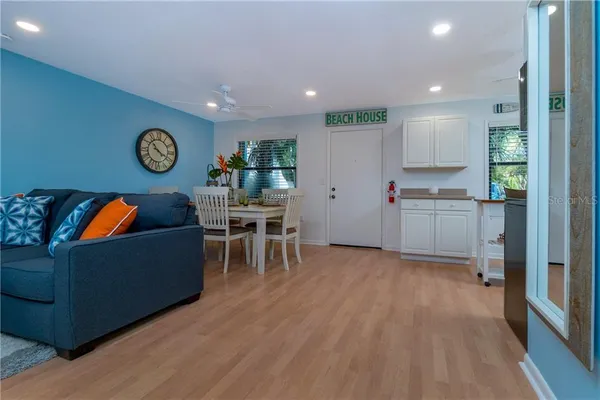 a living room with furniture and a wooden floor