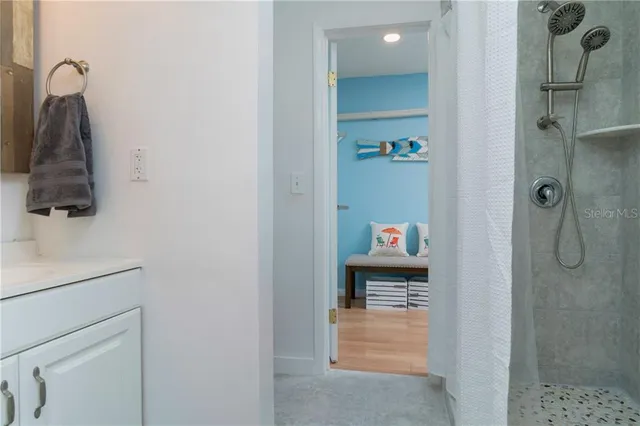 a bathroom with a shower and a sink