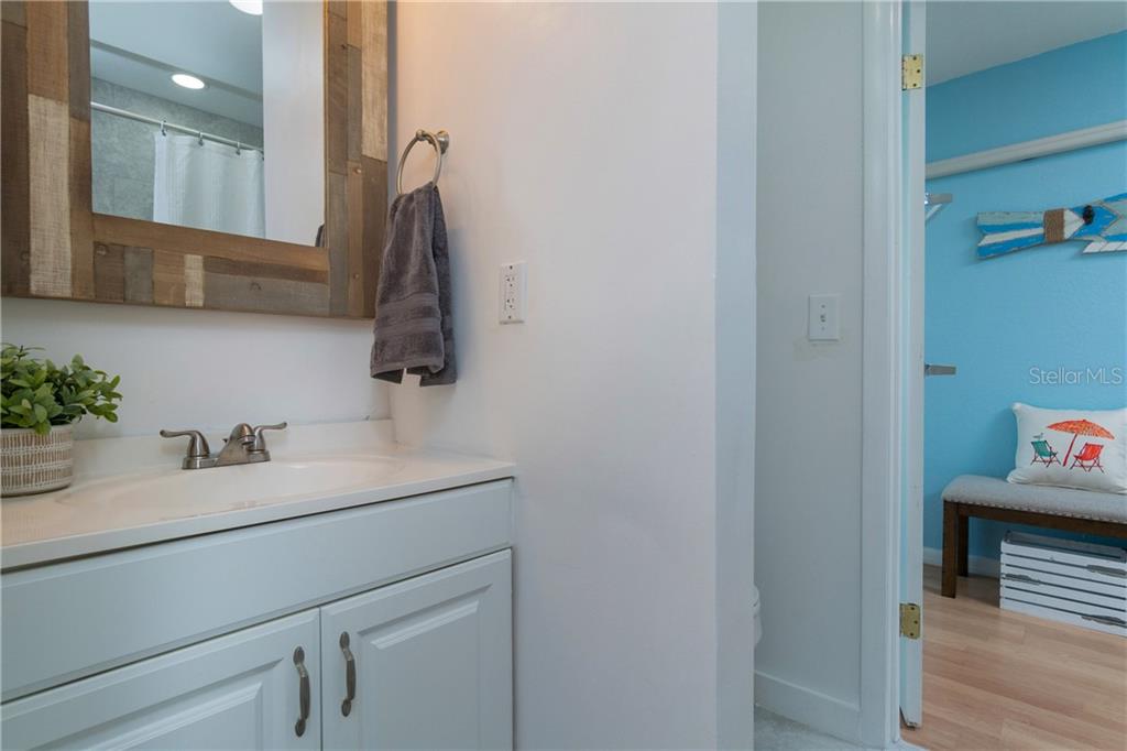 5041 North Beach Road, Unit 3B Englewood, FL 34223 - Photo 24 of 55 a bathroom with a sink and a mirror