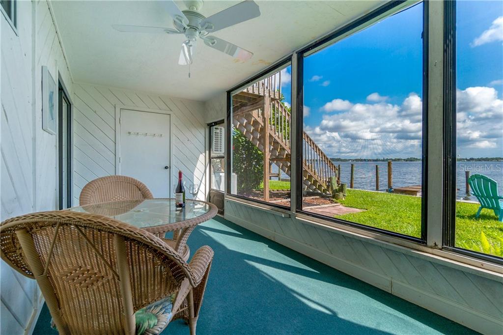 5041 North Beach Road, Unit 3B Englewood, FL 34223 - Photo 31 of 55 a view of a porch with furniture