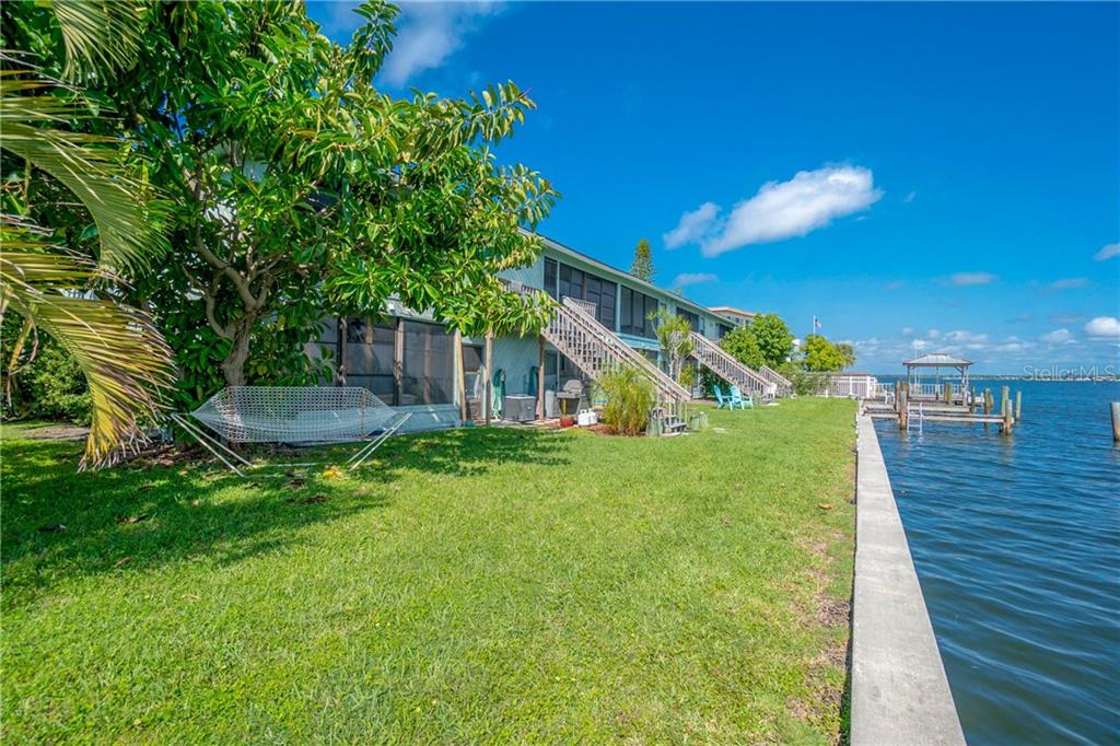 5041 North Beach Road, Unit 3B Englewood, FL 34223 - Photo 37 of 55 a view of a house with a yard