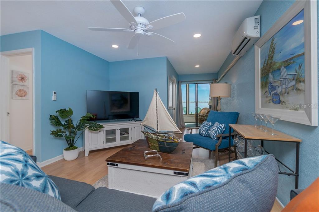 5041 North Beach Road, Unit 3B Englewood, FL 34223 - Photo 4 of 55 a living room with furniture and a flat screen tv