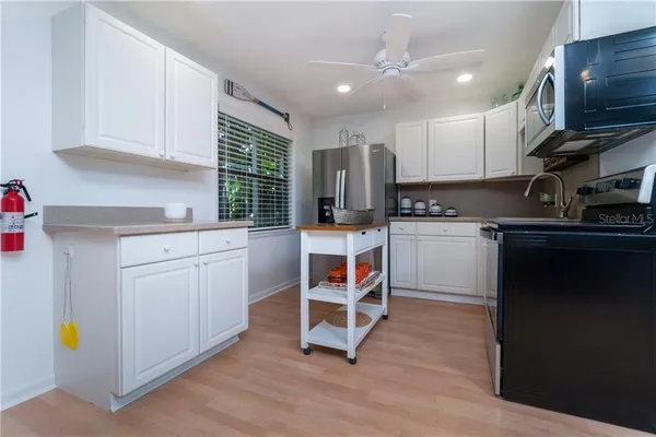 a kitchen with a sink cabinets and window