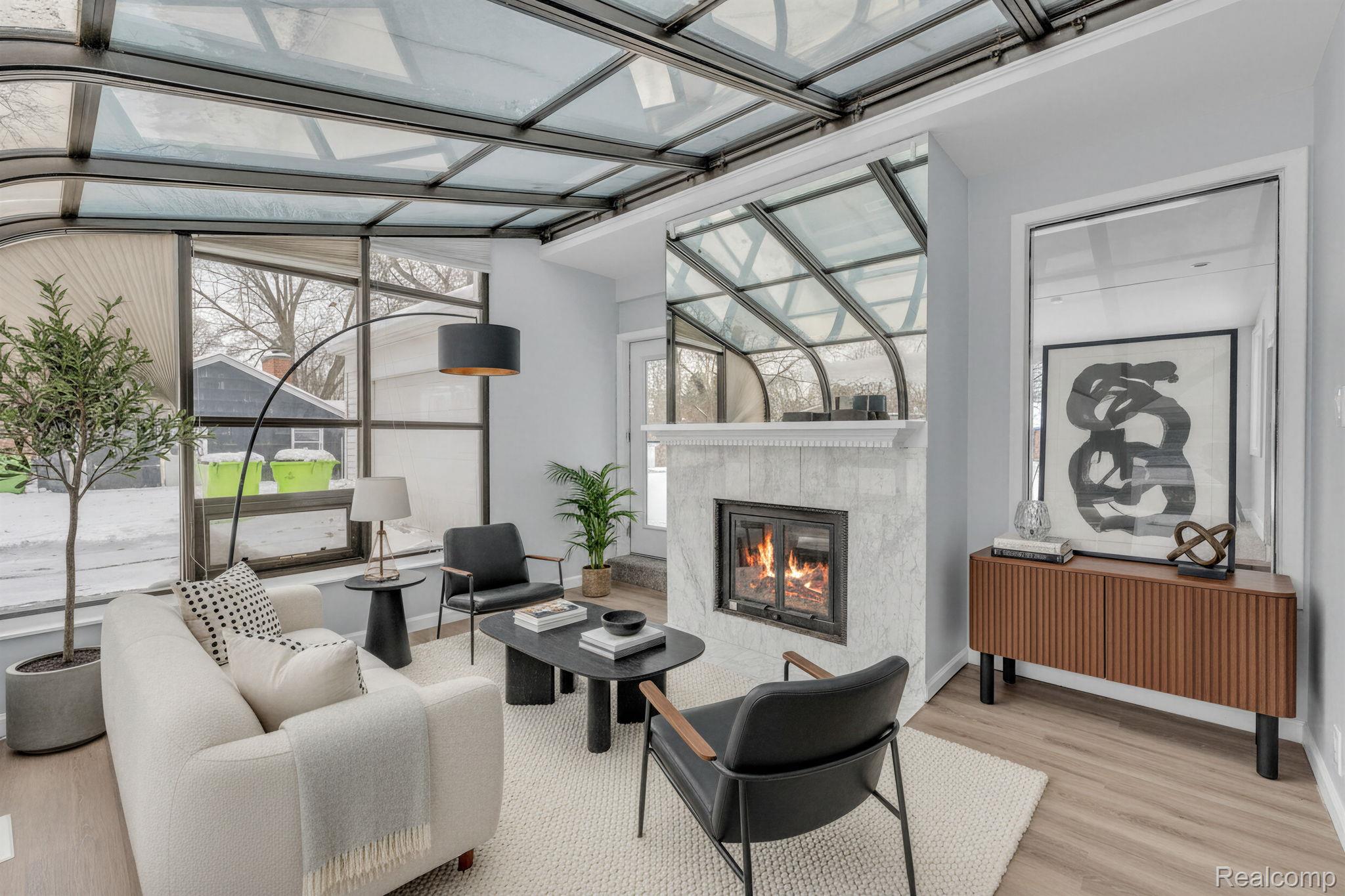 6576 Inkster Road West Bloomfield, MI 48322 - Photo 3 of 62 Living room with a fireplace, a sunroom, and wood finished floors