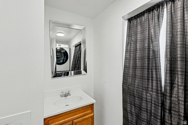 3689 Lasso Loop Circle Magna, UT 84044 - Photo 15 of 26 2nd bathroom downstairs with a white countertop and integrated sink, complemented by a large framed mirror
