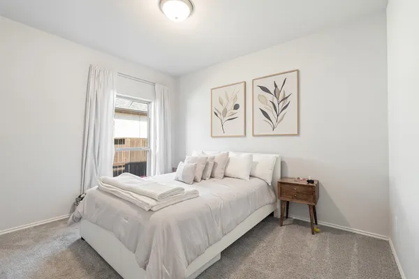 a bedroom with a bed and a window