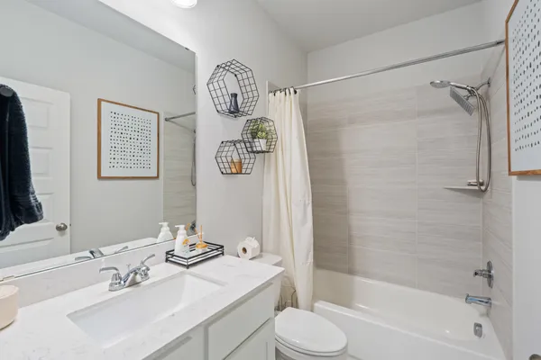 a bathroom with a sink mirror toilet and bathtub