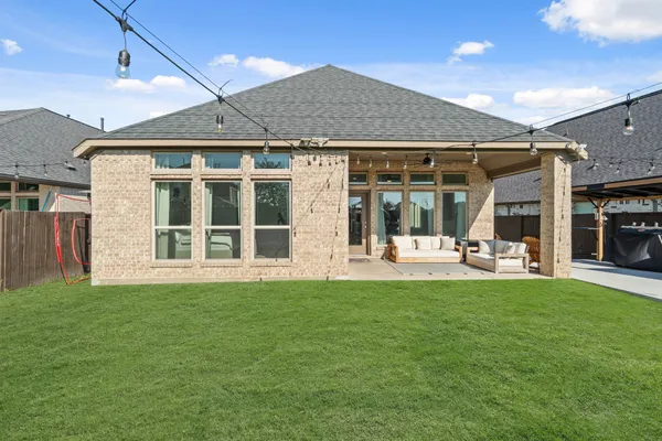 a view of a house with sitting area and garden