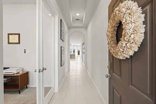 a view of a hallway with paintings on the wall