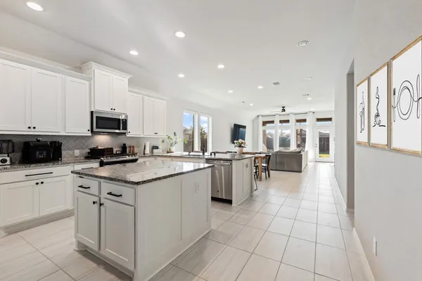 a kitchen with a sink appliances and cabinets
