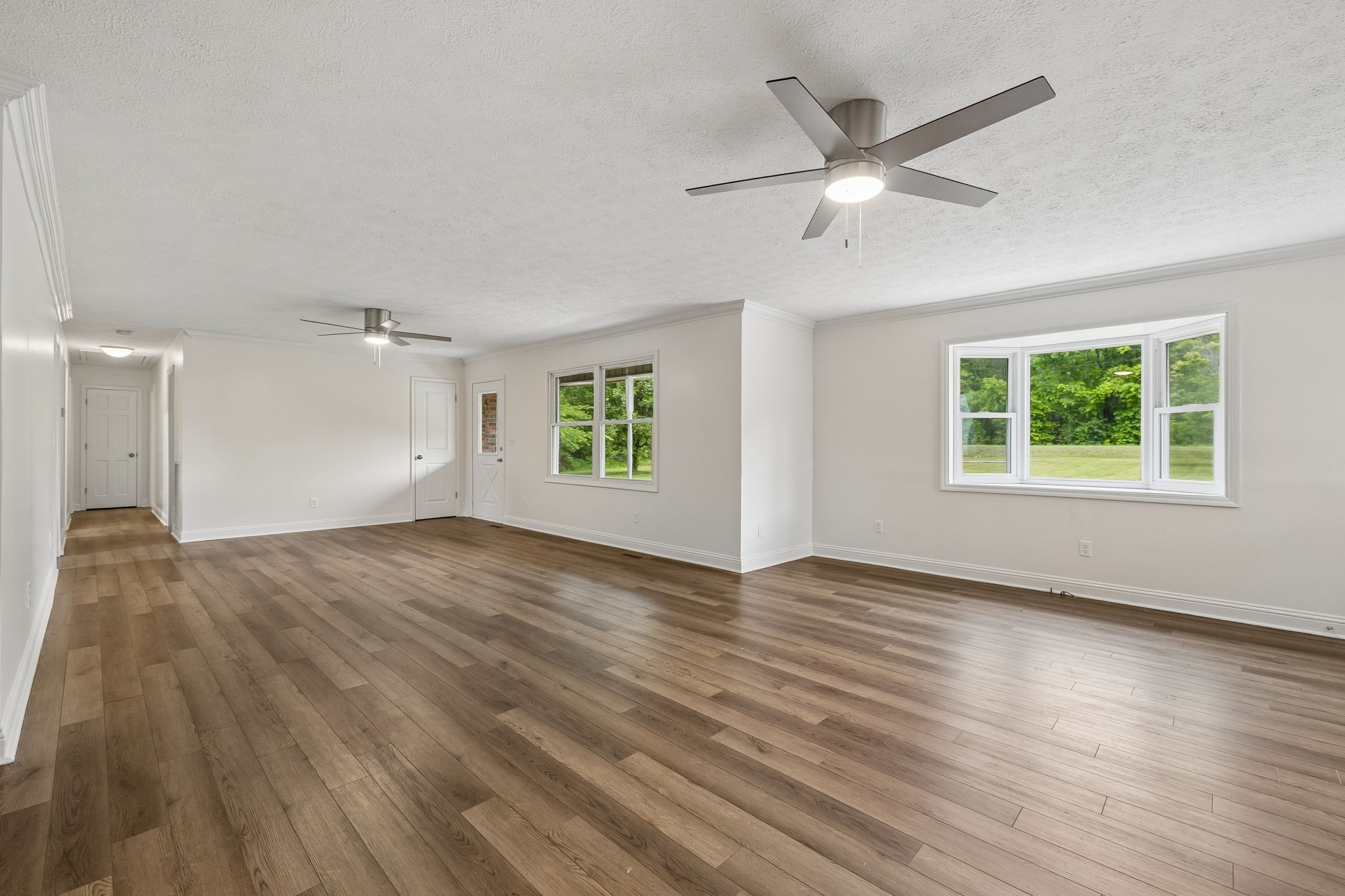 1397 East Blue Creek Road Waverly, TN 37185 - Photo 13 of 93 a view of an empty room with wooden floor and a window