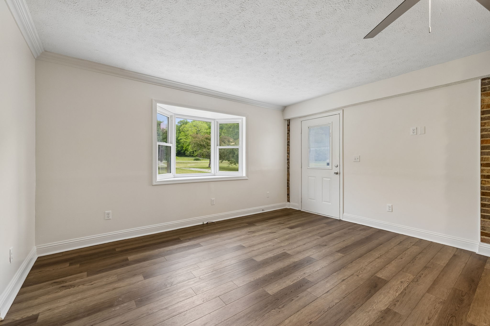1397 East Blue Creek Road Waverly, TN 37185 - Photo 15 of 93 an empty room with wooden floor and windows