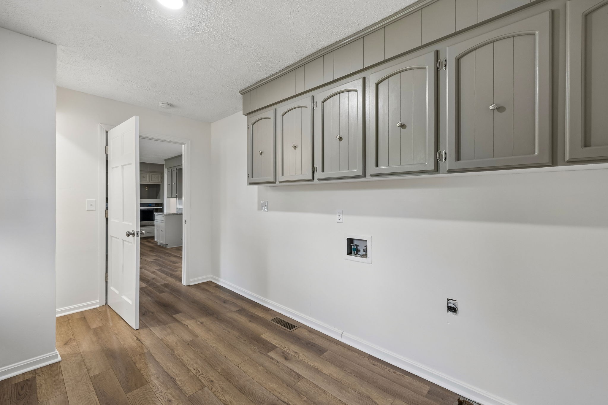 1397 East Blue Creek Road Waverly, TN 37185 - Photo 25 of 93 a view of a hallway with wooden floor and cabinets