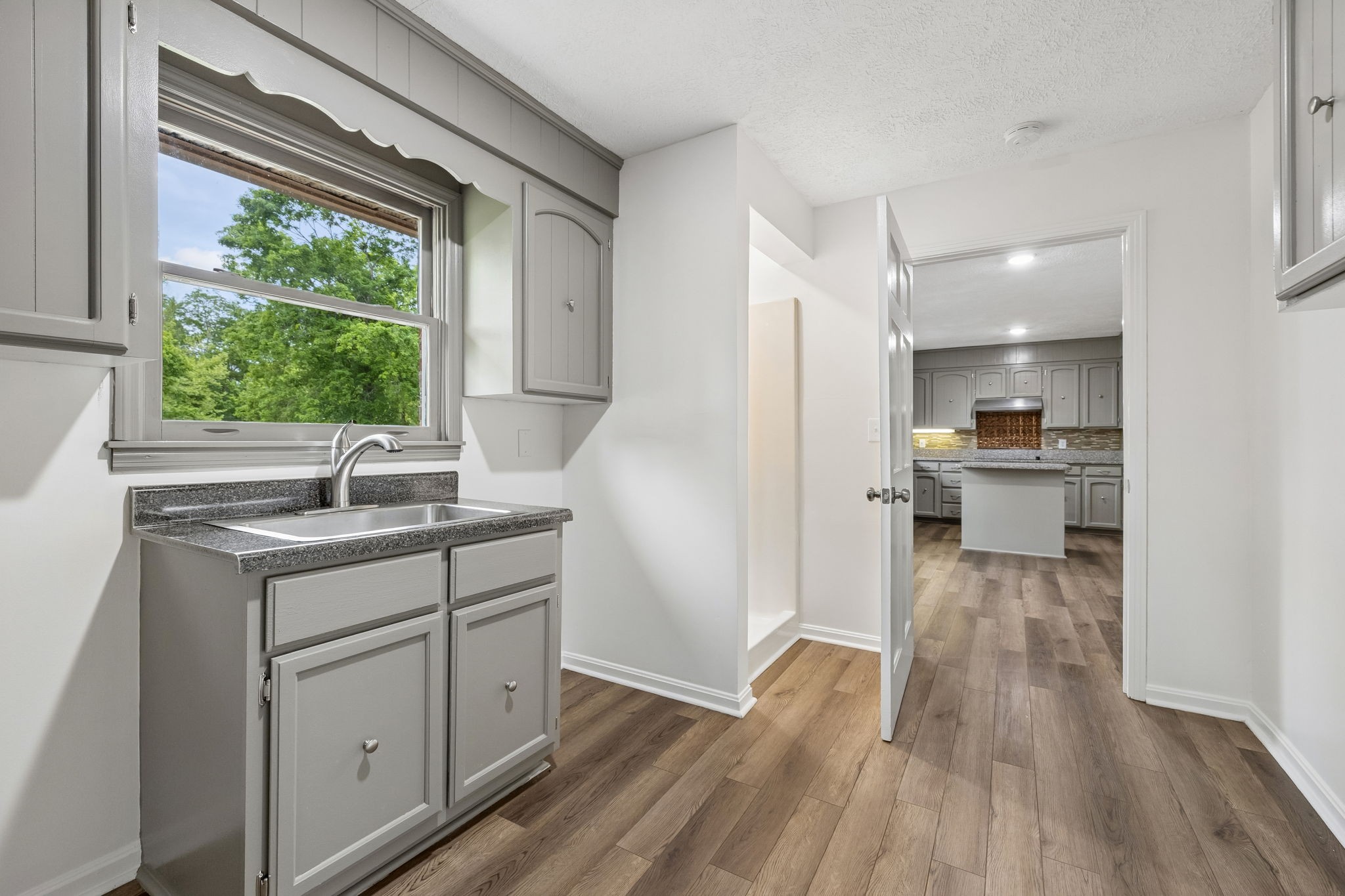 1397 East Blue Creek Road Waverly, TN 37185 - Photo 26 of 93 a kitchen with a sink and wooden floor