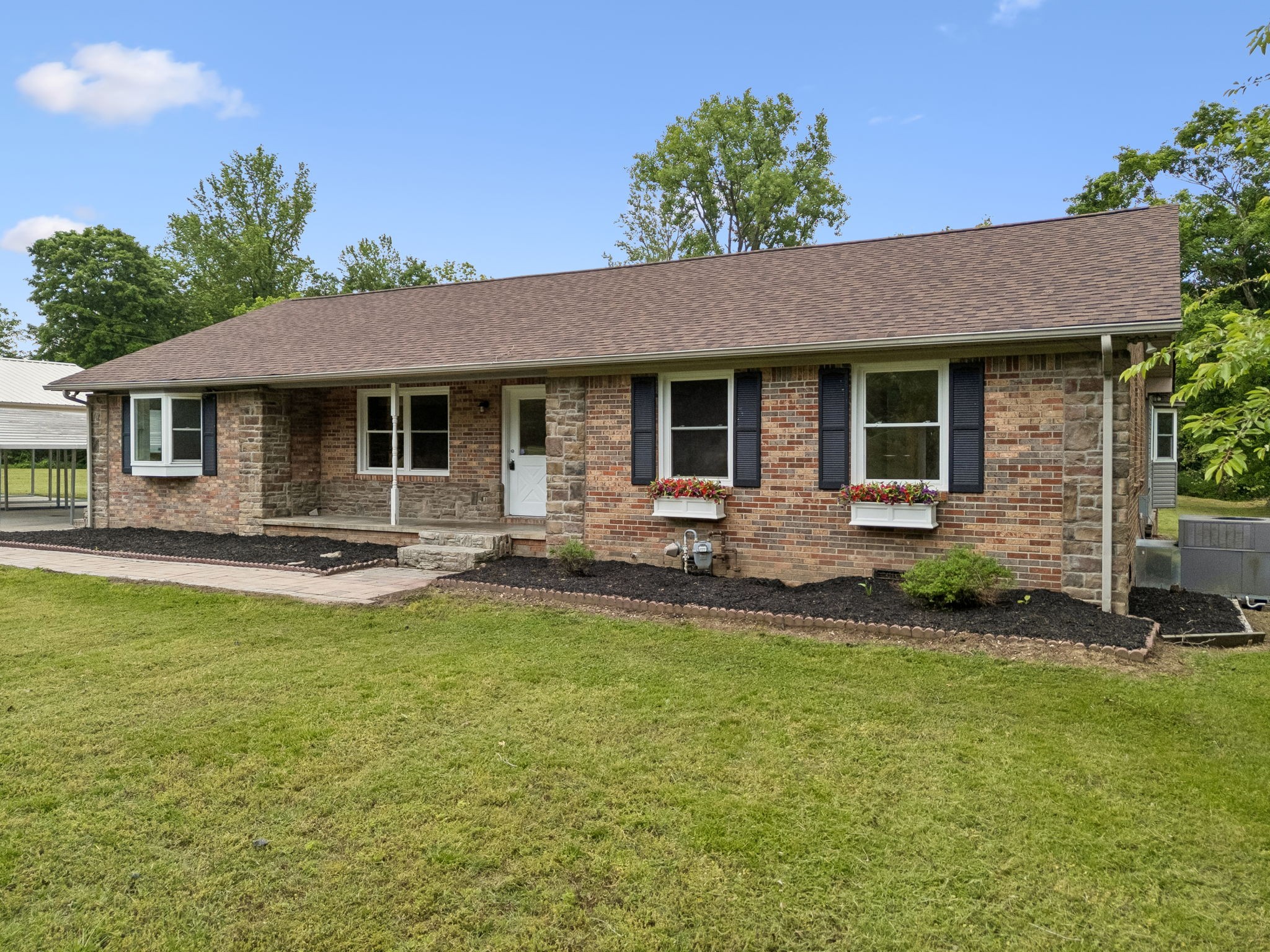 1397 East Blue Creek Road Waverly, TN 37185 - Photo 3 of 93 a front view of a house with swimming pool yard and outdoor seating