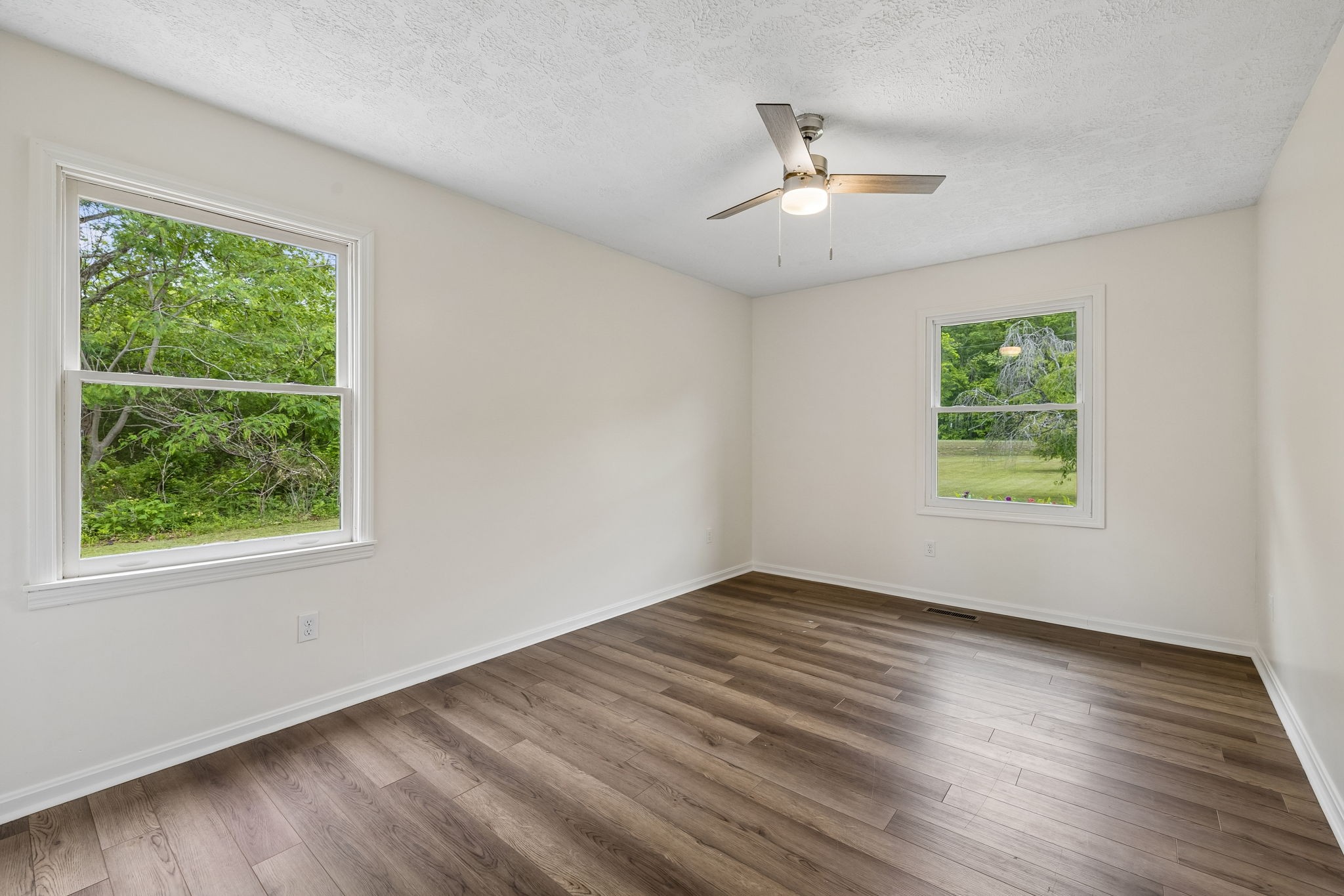 1397 East Blue Creek Road Waverly, TN 37185 - Photo 31 of 93 a view of an empty room with wooden floor and a window