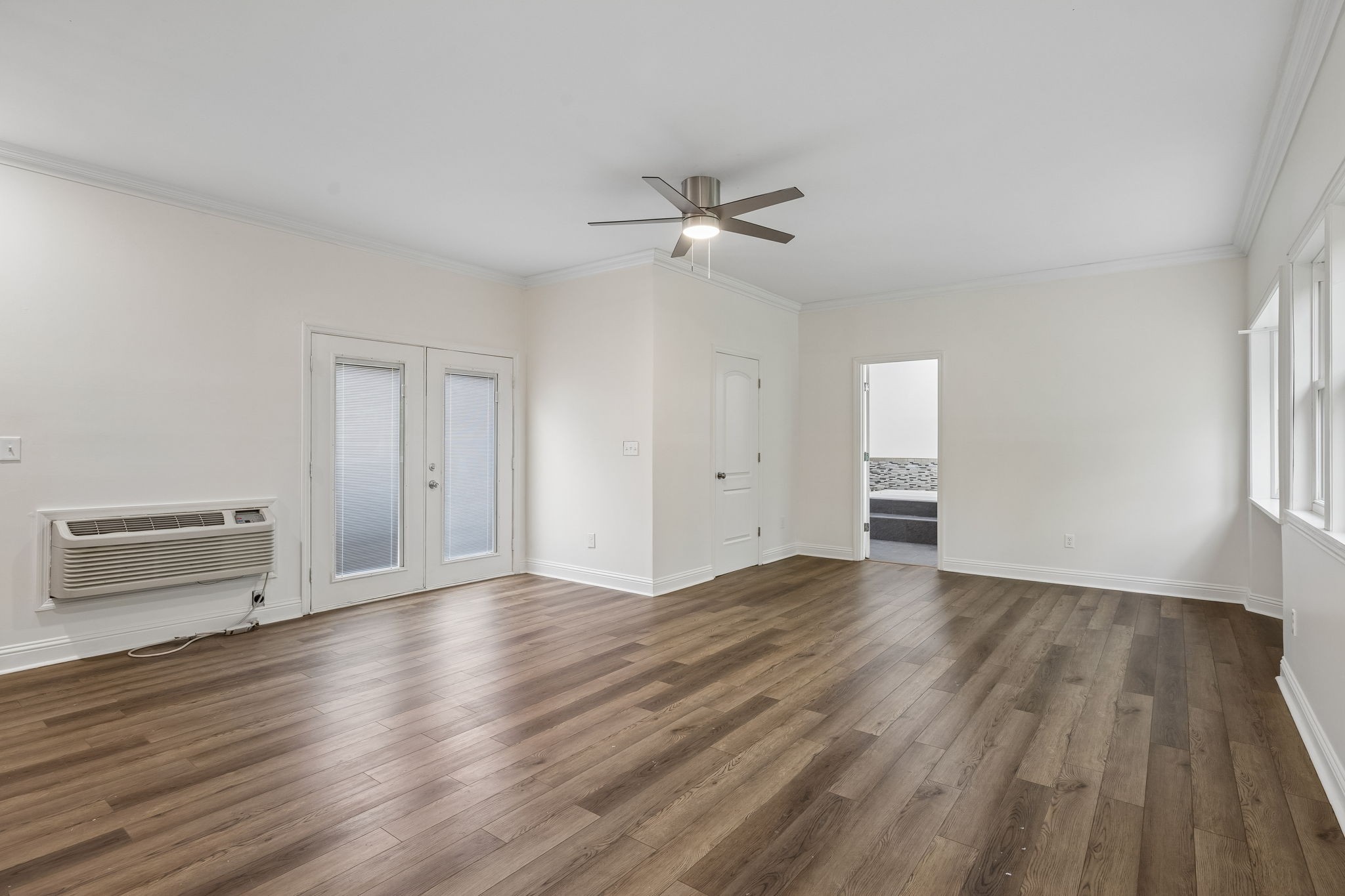 1397 East Blue Creek Road Waverly, TN 37185 - Photo 33 of 93 an empty room with wooden floor cabinet and windows