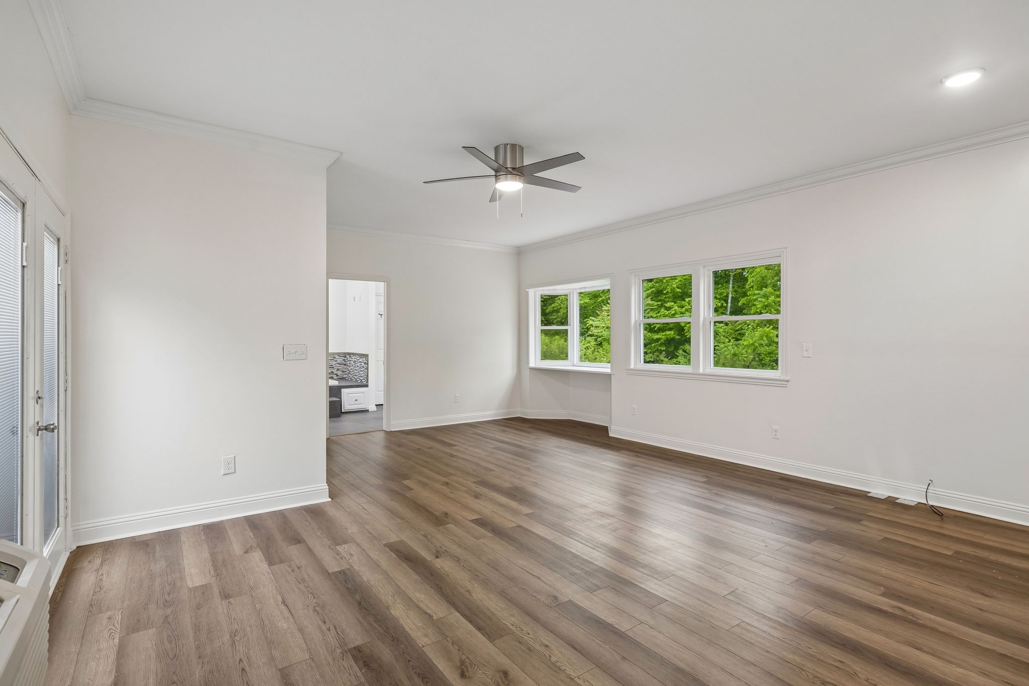 1397 East Blue Creek Road Waverly, TN 37185 - Photo 34 of 93 an empty room with wooden floor and windows