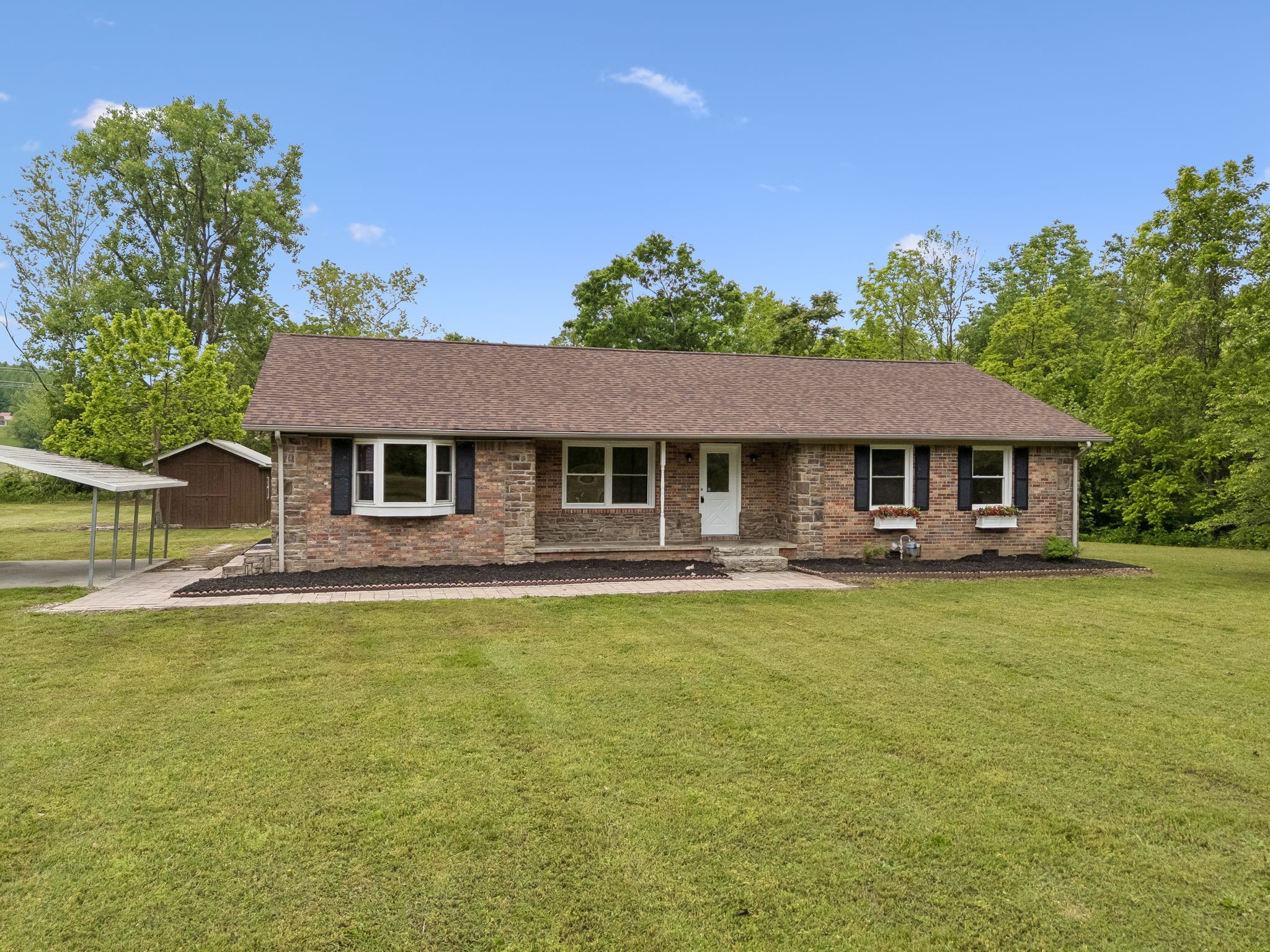1397 East Blue Creek Road Waverly, TN 37185 - Photo 4 of 93 a front view of a house with a garden