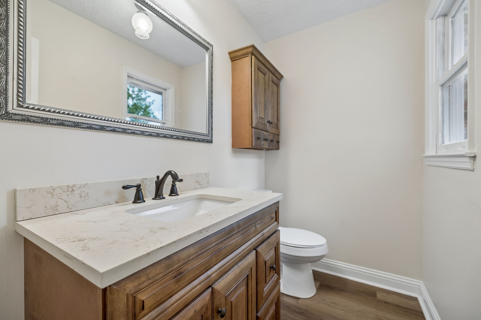 1397 East Blue Creek Road Waverly, TN 37185 - Photo 41 of 93 a bathroom with a sink a toilet and a mirror