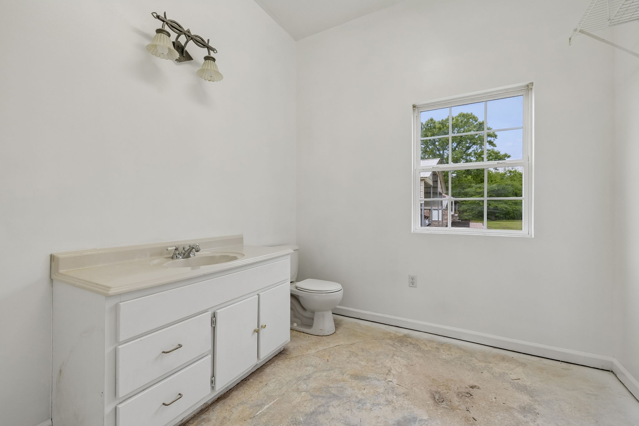 1397 East Blue Creek Road Waverly, TN 37185 - Photo 57 of 93 a bathroom with a toilet sink and window