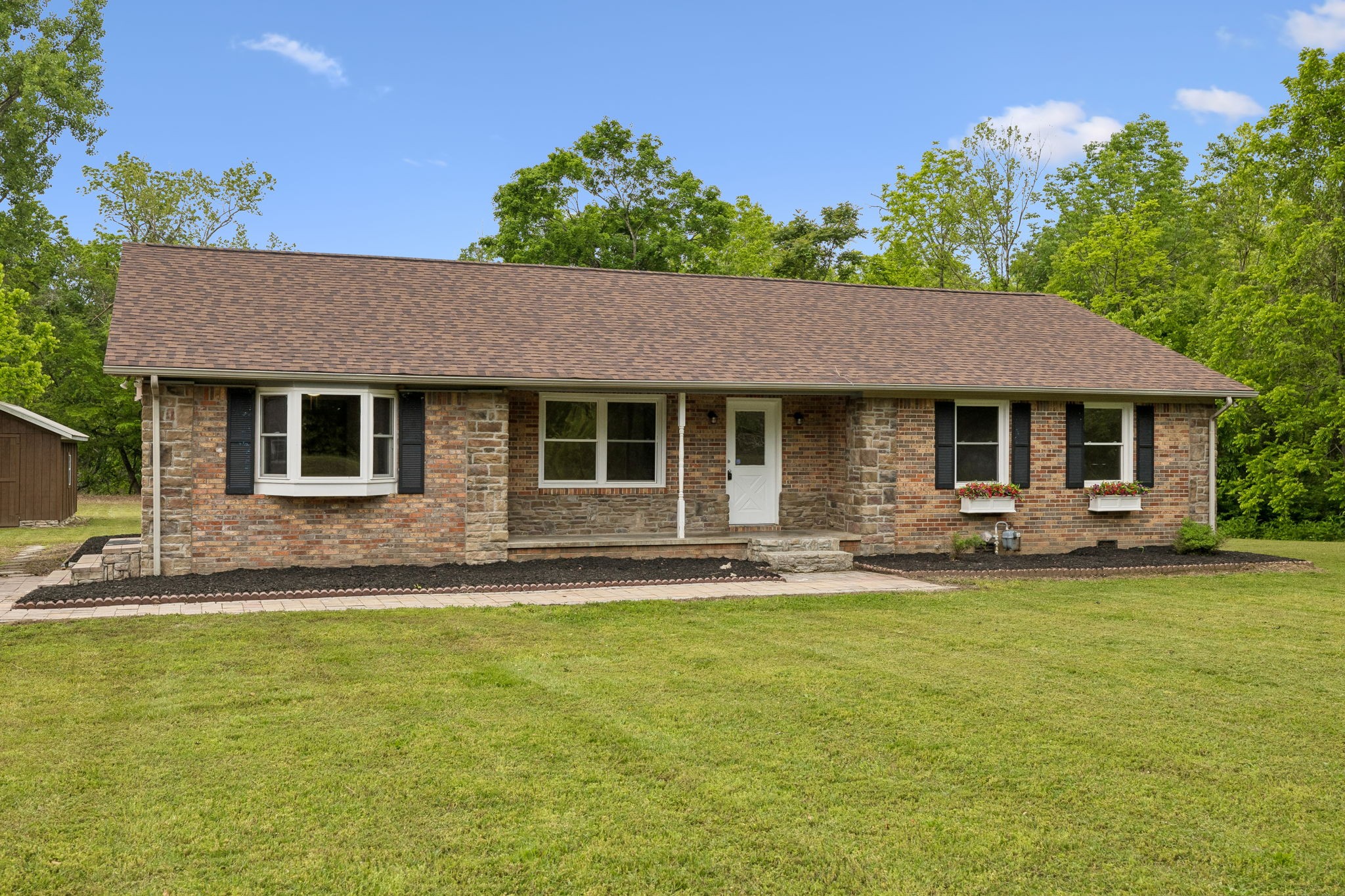 1397 East Blue Creek Road Waverly, TN 37185 - Photo 90 of 93 a front view of a house with a garden and yard