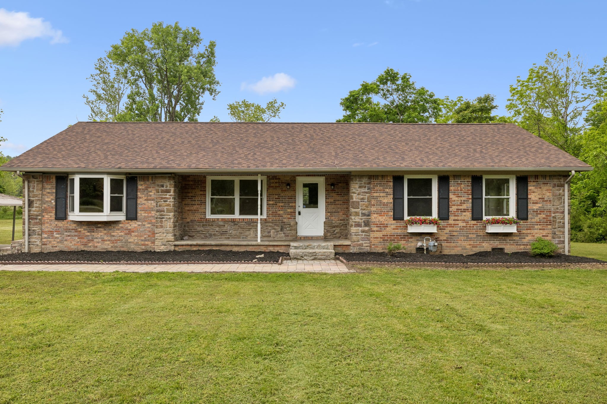 1397 East Blue Creek Road Waverly, TN 37185 - Photo 91 of 93 a front view of a house with a garden and yard