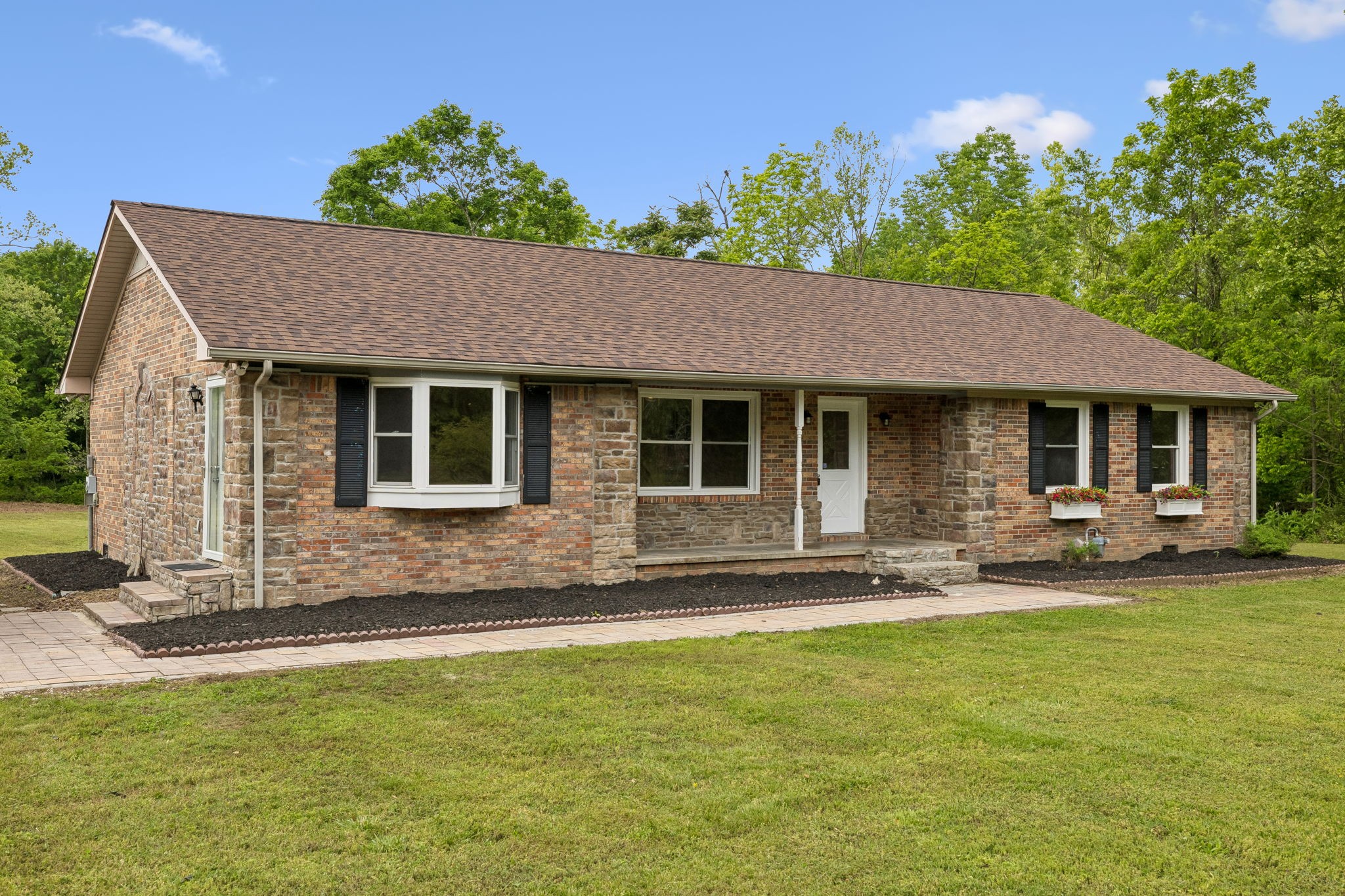 1397 East Blue Creek Road Waverly, TN 37185 - Photo 93 of 93 a front view of a house with a garden and patio