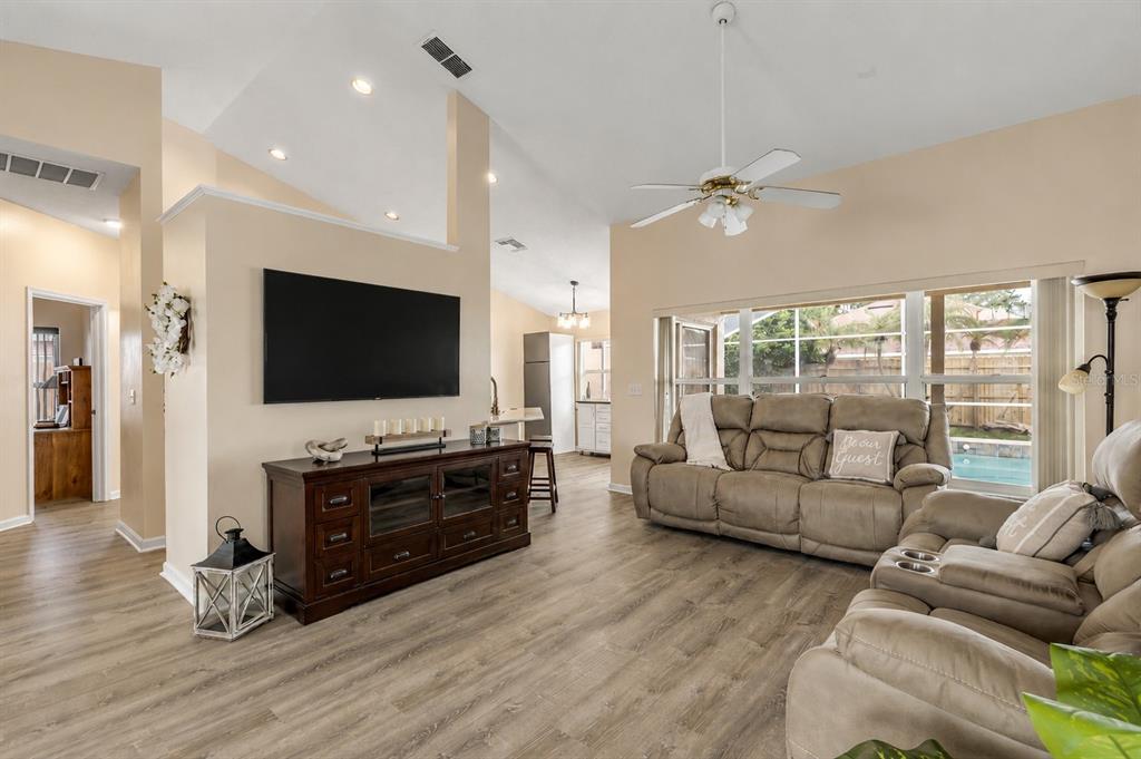 12232 Bronson Way Orlando, FL 32824 - Photo 2 of 32 a living room with furniture and a flat screen tv