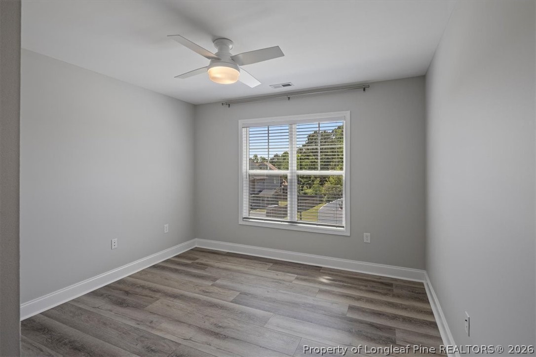 134 Huzzas Circle Cameron, NC 28326 - Photo 14 of 31 an empty room with wooden floor and windows