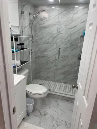 a bathroom with a toilet and a shower