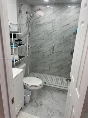 a bathroom with a toilet and a shower