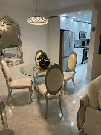 a living room with furniture a dining table and chairs