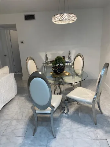 a room with a table chairs and a dining table