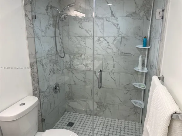 a bathroom with a toilet and shower