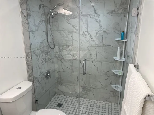 a bathroom with a toilet and shower